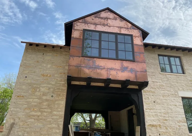 Copper metal panel facade on a stone building for Metal Roof Coating in Ridley