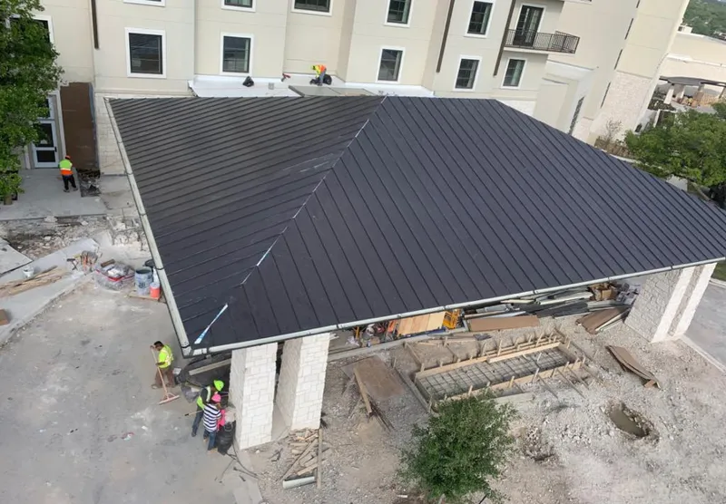 Metal roofing installation team working on a commercial building in Ridley
